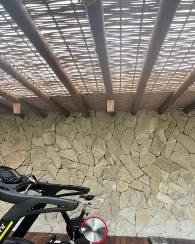 Área com pergolado e parede de Pedra Atacama